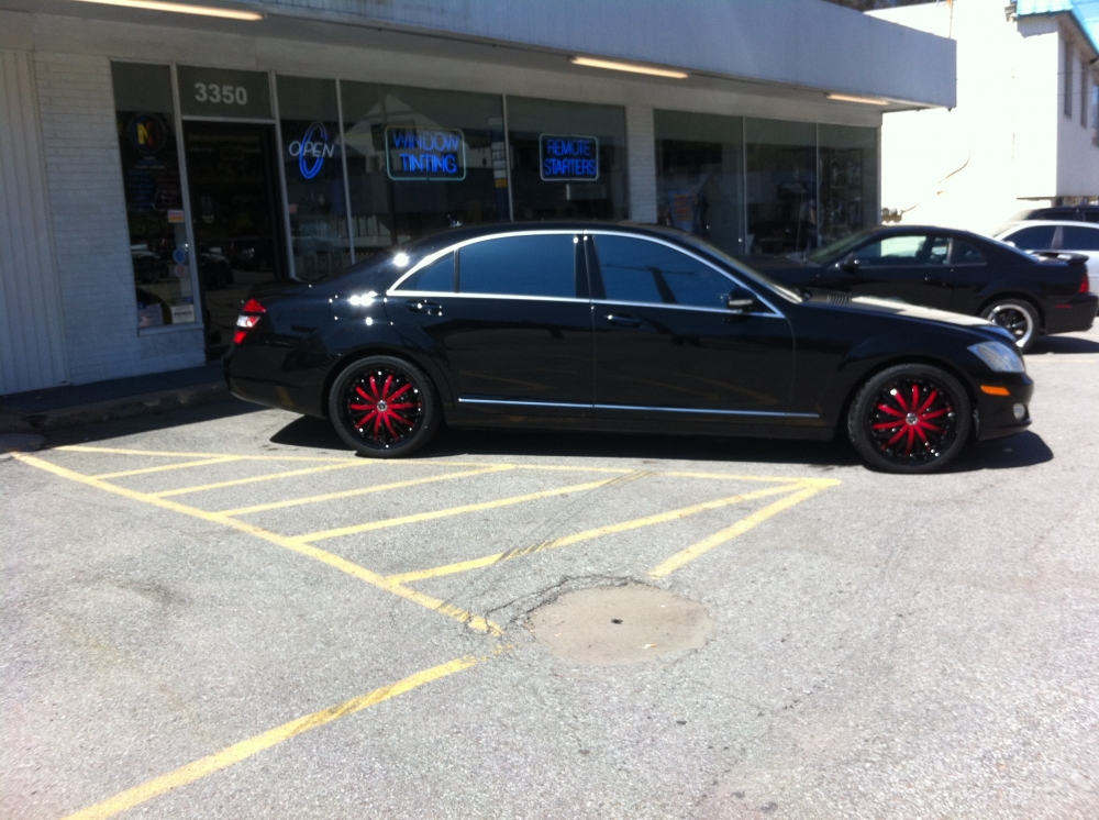 Black car with custom red tire rims